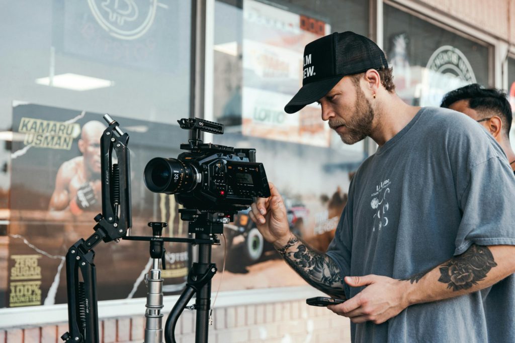 Filmmaker adjusting camera