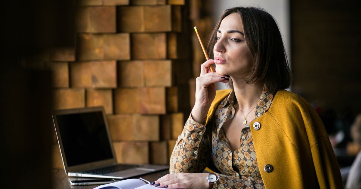 Woman thinking with a pencil